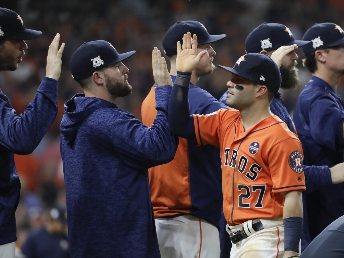 Houston Astros' Jose Altuve celebrates with teammates after Game 1 of baseball's American League Championship Series against the New York Yankees Friday, Oct. 13, 2017, in Houston. The Astros won 2-1 to take a 1-0 lead in the series. (AP Photo/David J. Phillip)