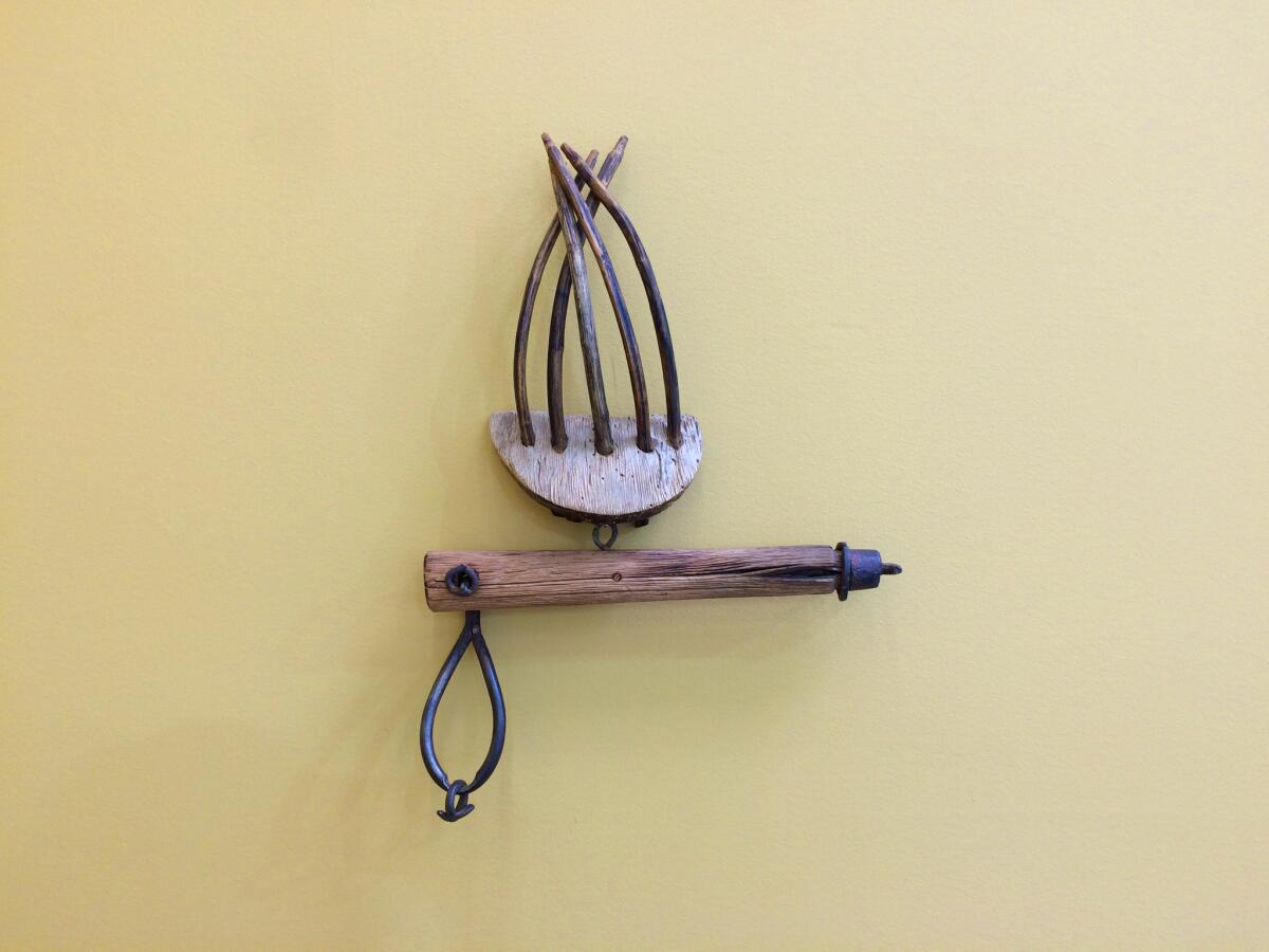 "Hooked," a mixed media piece by John Outterbridge from 2009, evokes the violence of an extended claw.