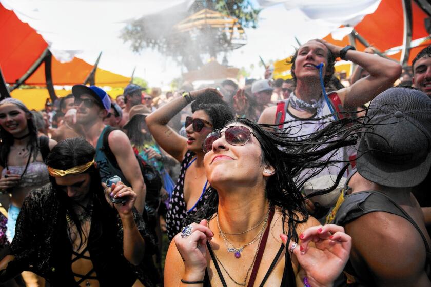 Music fans revel in the loud beats at the water-drenched dance floor at the Do Lab during Day 1 of the Coachella Valley Music and Arts Festival in Indio, Calif., on April 10, 2015.