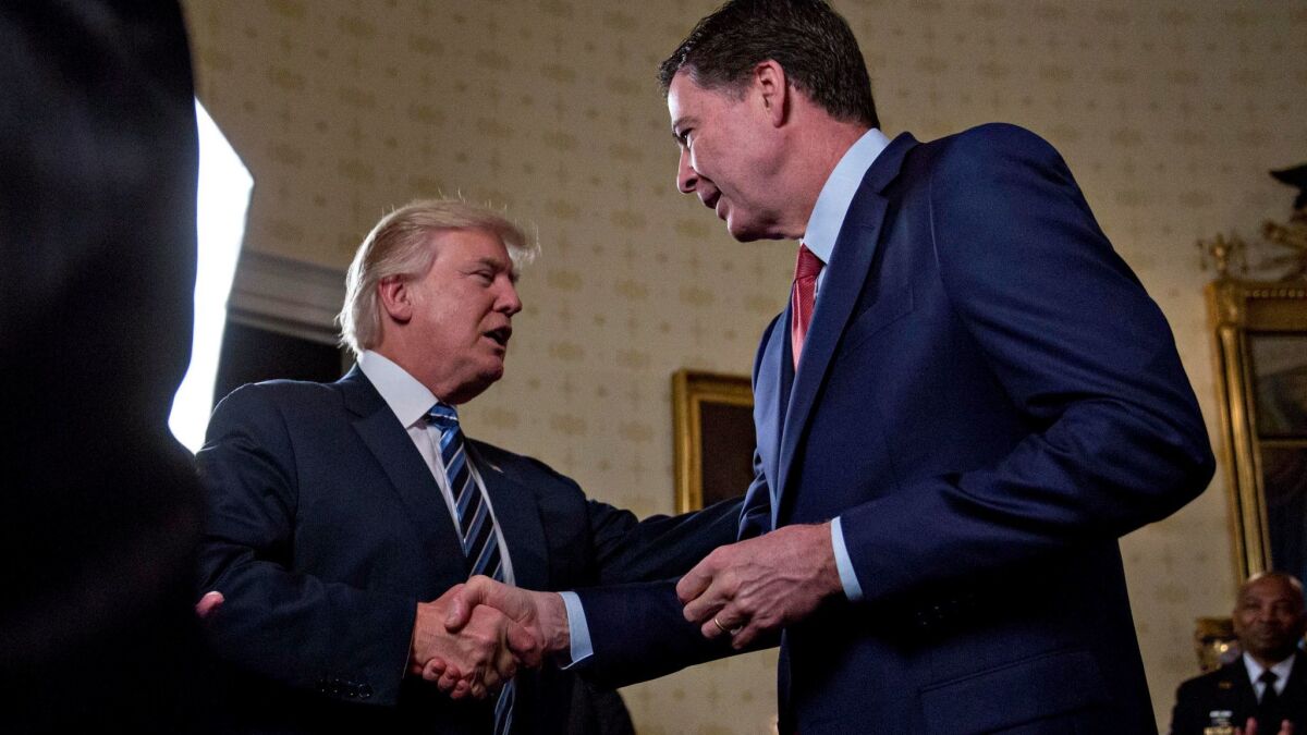 President Trump shakes hands with James B. Comey, then-director of the FBI, during a reception at the White House on Jan. 22.