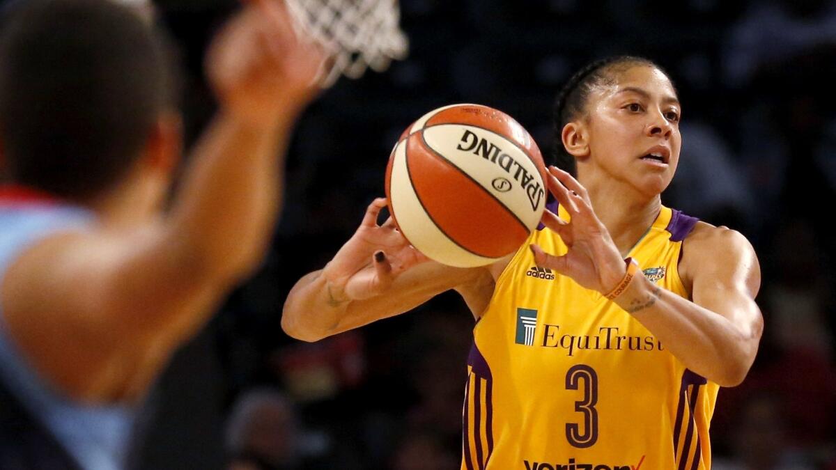 Sparks forward Candace Parker makes a no-look pass against the Dream during a win last month.
