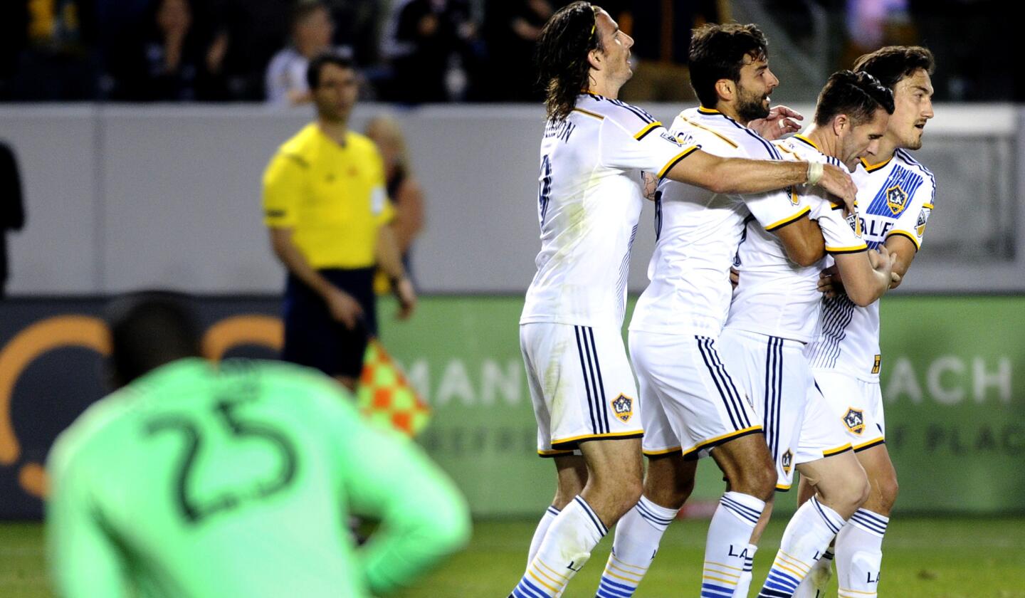 Galaxy teammates mob Robbie Keane, second from right, after he scored late in the second half against the Fire on Friday night at StubHub Center.