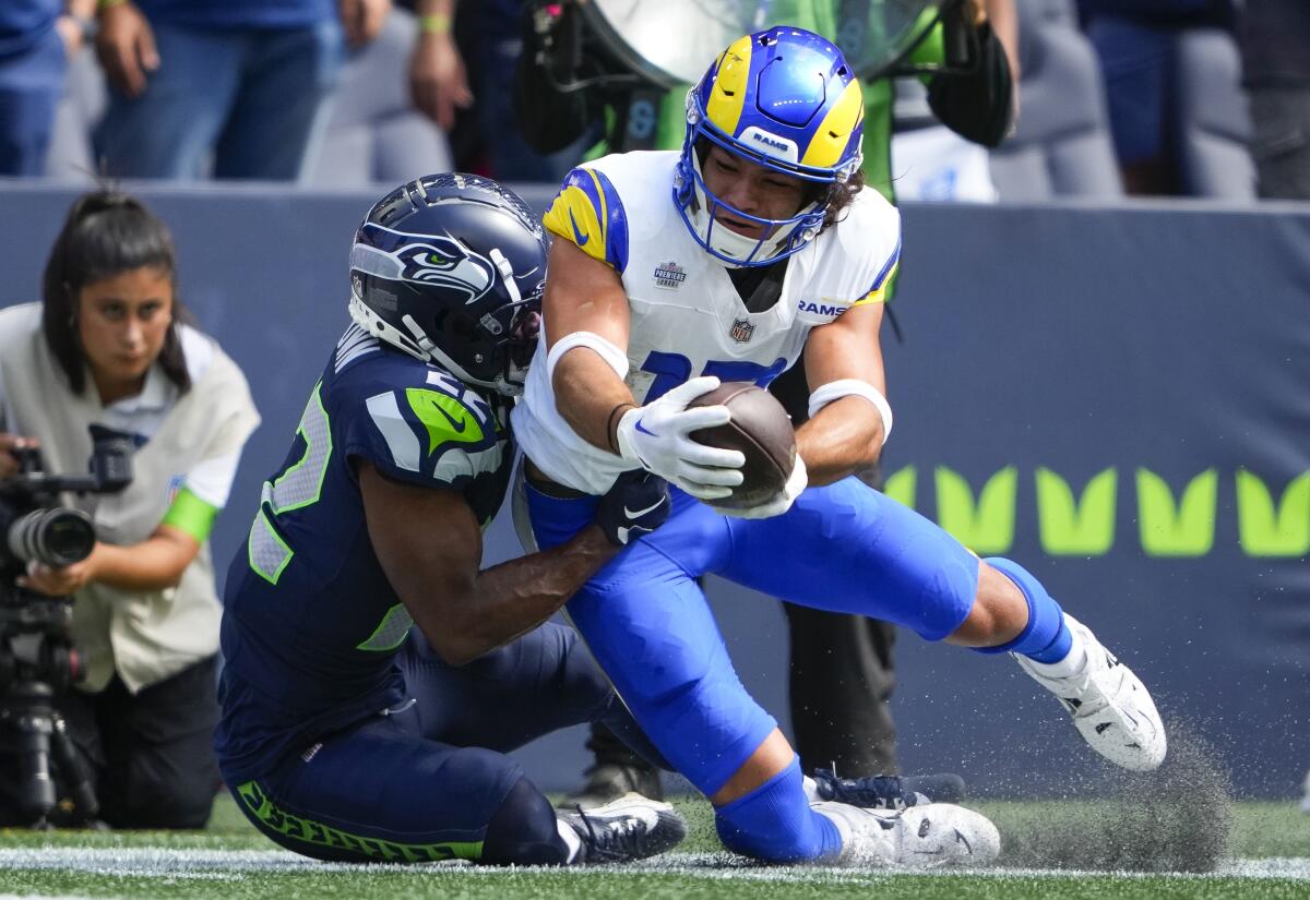  After making a catch, Rams receiver Puka Nacua is tackled by Seahawks cornerback Tre Brown. 