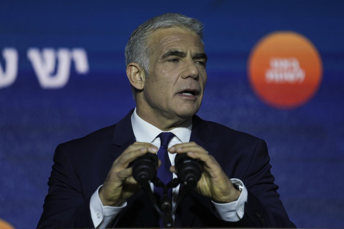 FILE - Israeli Prime Minister and the head of Yesh Atid party, Yair Lapid, speaks to his supporters after first exit poll results for the Israeli Parliamentary election at his party's headquarters in Tel Aviv, Israel, Nov. 2, 2022. Lapid issued a plea for national unity, on Sunday. Nov. 6, 2022, days after he was defeated in national elections by the former premier, Benjamin Netanyahu, with the backing of a far-right ultranationalist party. (AP Photo/Ariel Schalit, File)