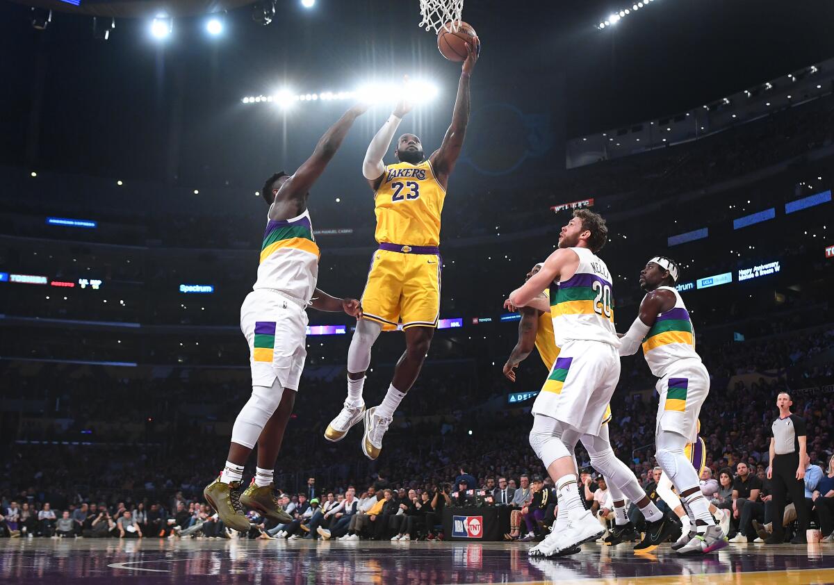 LeBron James scores against Zion Williamson on Tuesday at Staples Center