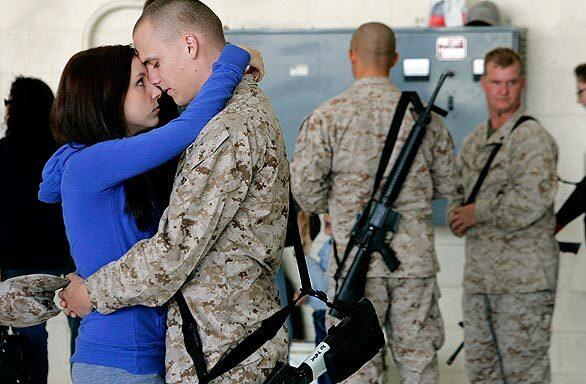 Marine Sgt. Benjamin Butterworth shares a moment with his wife, Jamie, during a deployment ceremony for the Light Attack Helicopter Squadron 369 at Camp Pendleton.