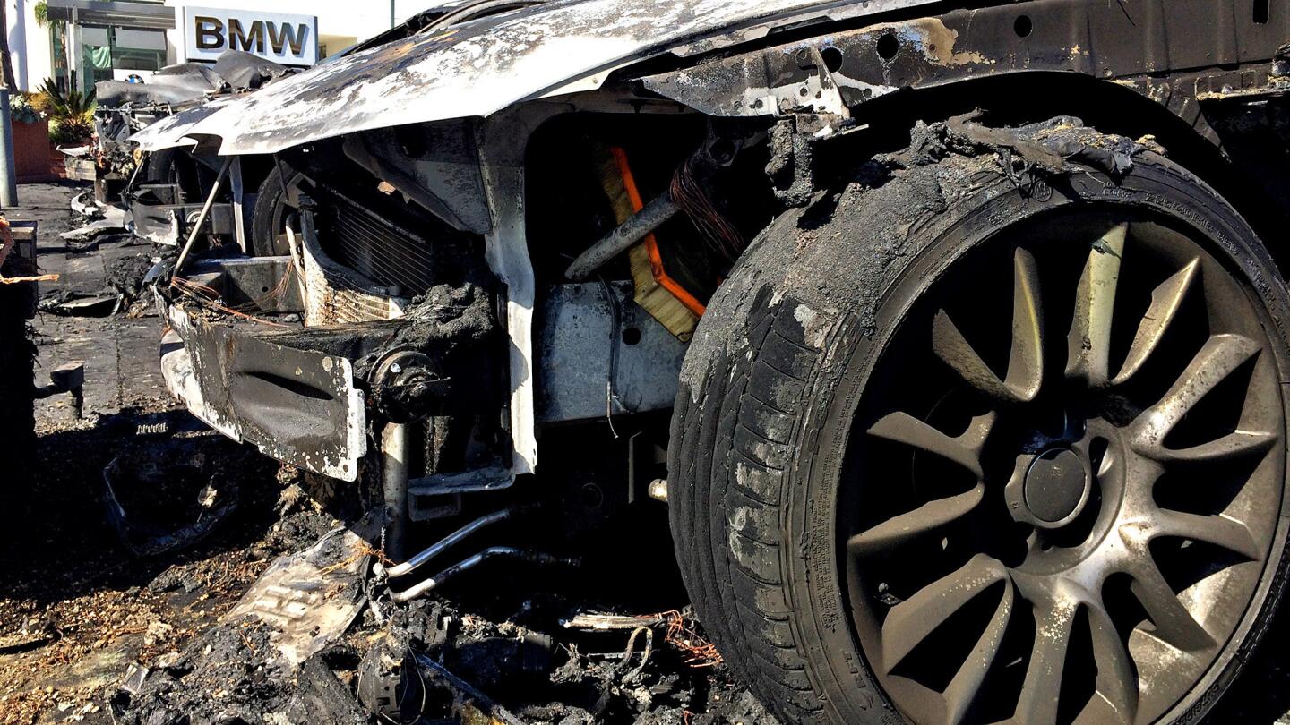 The burnt-out remains of five late-model used BMWs on the sales lot at Santa Monica BMW on Thursday after an arsonist set them ablaze Wednesday night. The total loss was estimated to be $250,000.