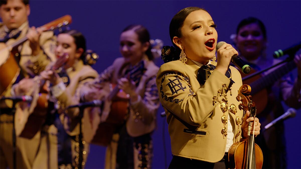 A woman sings in a scene from "Going Varsity in Mariachi."