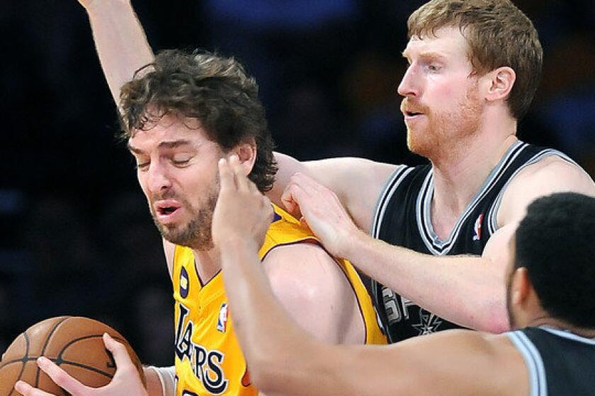 Lakers power forward Pau Gasol is double-teamed by Spurs forward Matt Bonner and guard Cory Joseph during a playoff game last season. He missed 33 games last season with knee and foot problems.