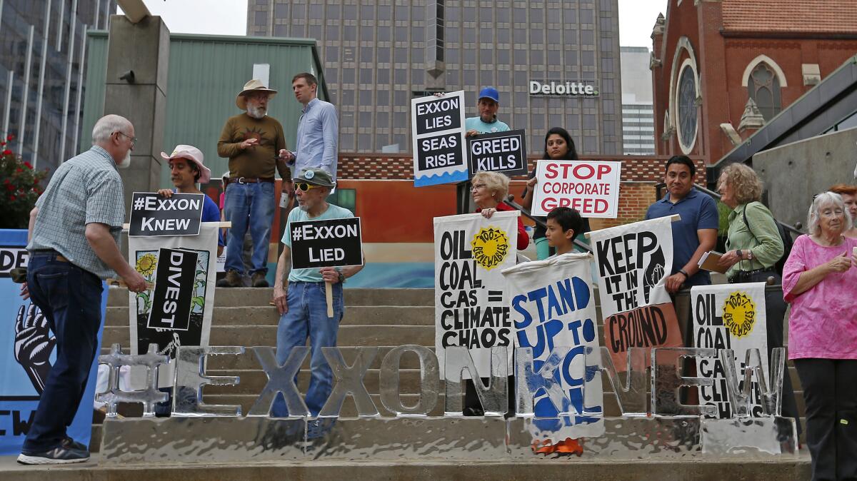 People protest outside the Exxon Mobil annual shareholder meeting in Dallas on May 25.