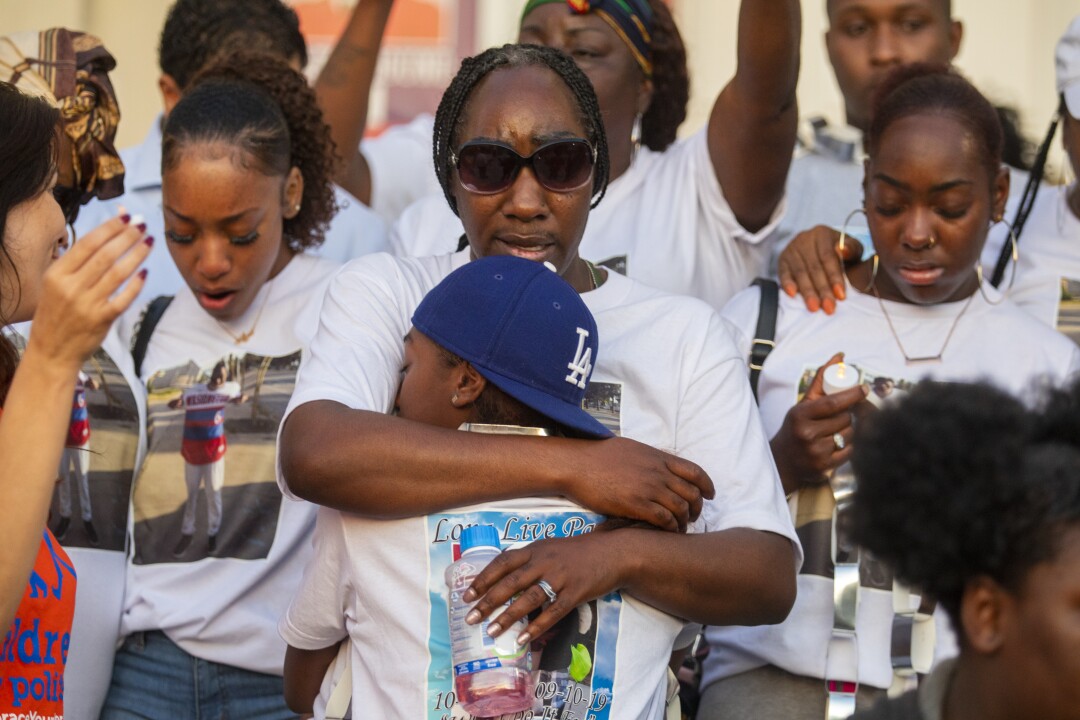 Kawana Anderson holds her daughter Heaven-Leigh Givan, during vigil in 2019.