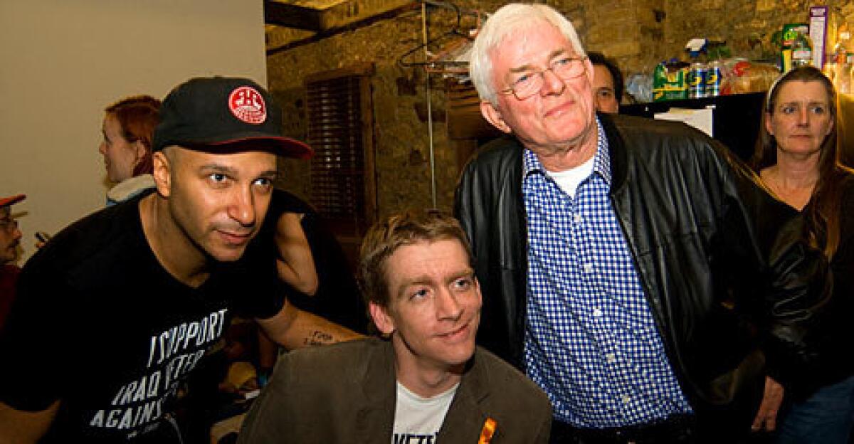 SUPPORT: Flanking paralyzed Iraq war vet Tomas Young are musician Tom Morello, left, and Phil Donahue.