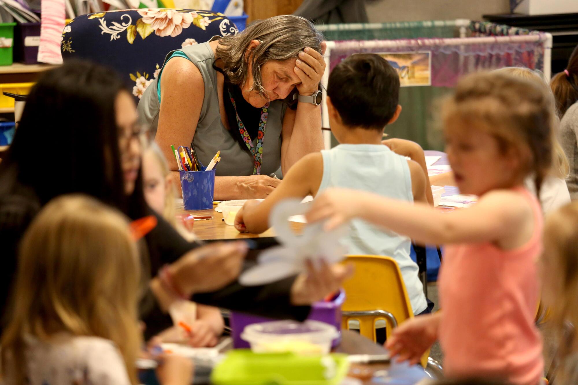 A teacher works with students in a combined transitional kindergarten and kindergarten class in Alturas, Calif.