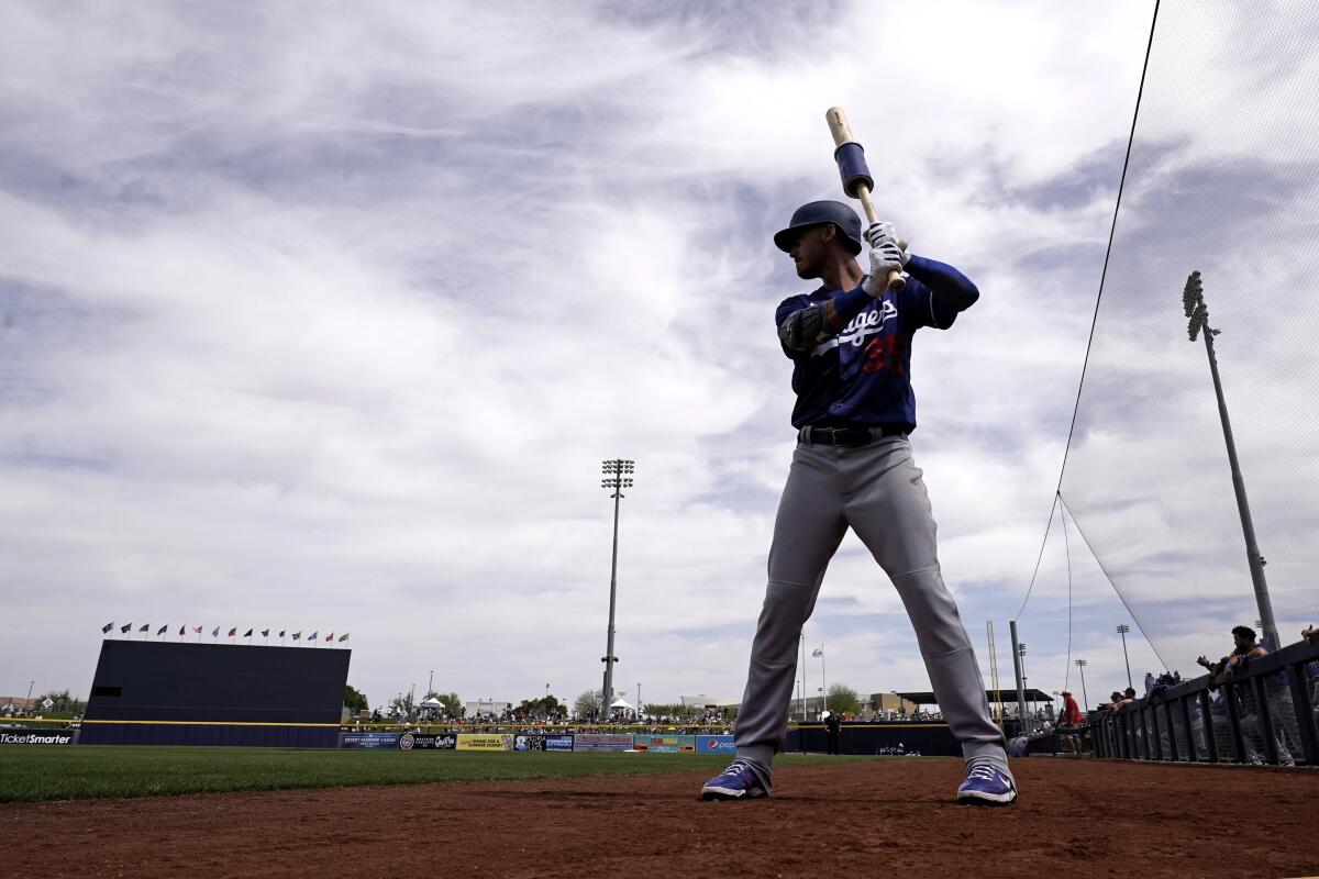 The Dodgers' Cody Bellinger gets ready to bat before a spring training game against the Mariners 