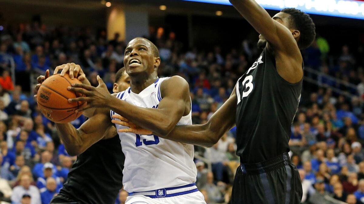Seton Hall's Isaiah Whitehead tries to score on a drive against Xavier's Trevon Bluiett, left, and Makinde London (13) during the second half Sunday.