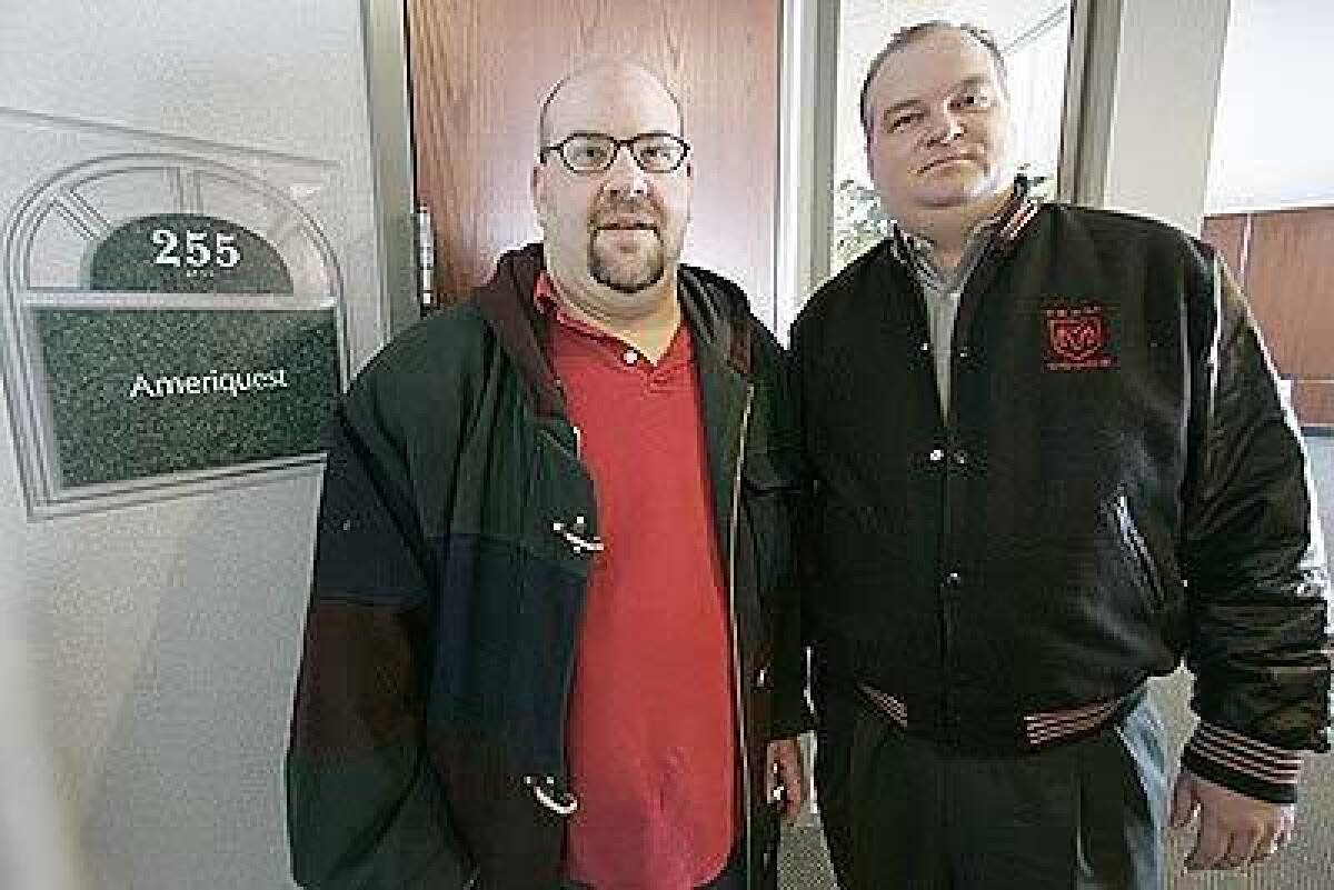 EMPLOYEE GRIPES: Former Ameriquest workers Mark Bomchill, left, and Troy Huston, shown in January outside the Plymouth, Minn., office they used to work at, have criticized the firms tactics.