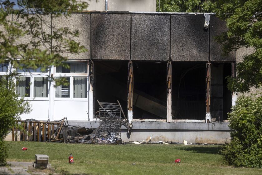 Remnants of a fire on the front of a refugee shelter in Apolda, Germany, Sunday June 4, 2023. Police said the fire broke out around 5 a.m. Sunday and that one person had died. A local government spokesperson said the shelter housed 300 people and was evacuated. (Michael Reichel/dpa via AP)