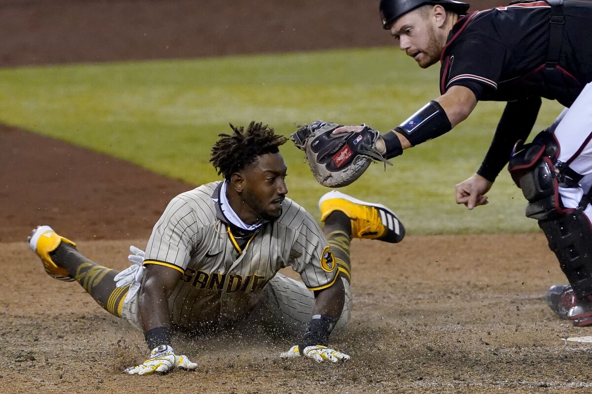 San Diego Padres' Jorge Mateo is tagged out by Arizona Diamondbacks catcher Carson Kelly for the final out of the game during the ninth inning of a baseball game Saturday, Aug. 15, 2020, in Phoenix.The Diamondbacks won 7-6. (AP Photo/Matt York)