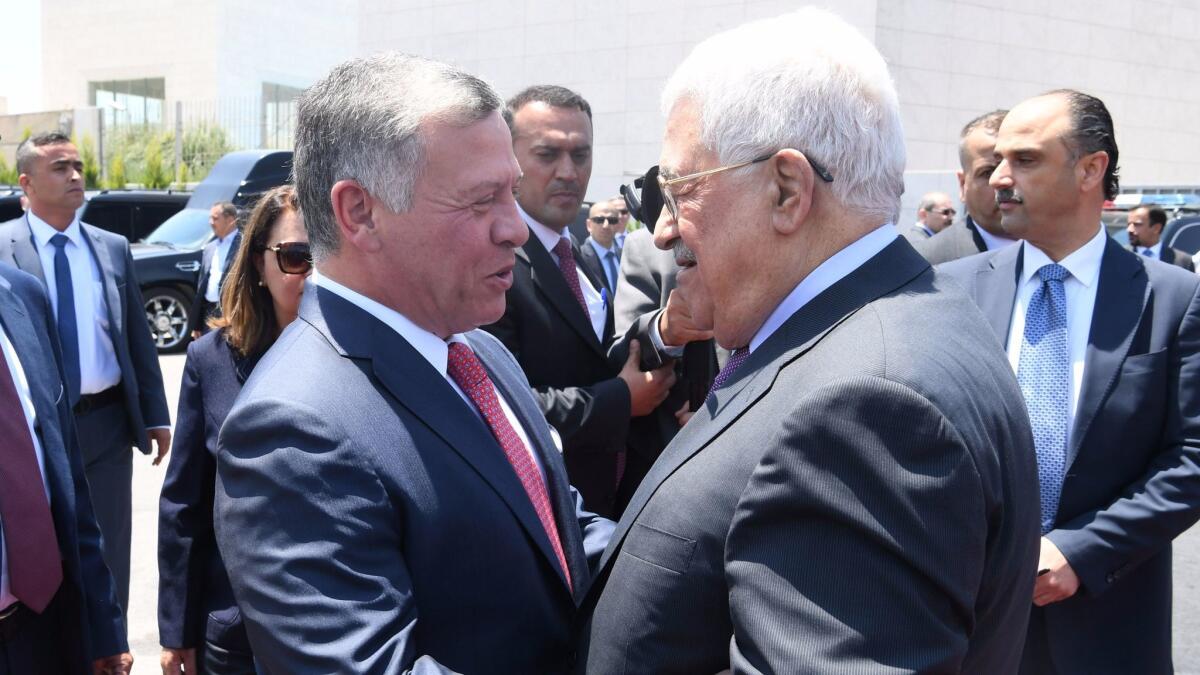 King Abdullah II of Jordan, left, is greeted by Palestinian Authority President Mahmoud Abbas during his visit on Aug. 7, 2017, in Ramallah, West Bank.