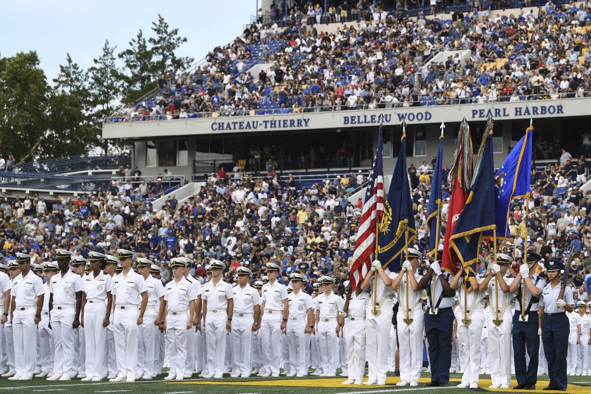 The Brigade of Midshipmen stand at attention during pre-game ceremonies before an NCAA college football game between Navy and Air Force, Saturday, Sept. 11, 2021, in Annapolis, Md. (AP Photo/Terrance Williams)