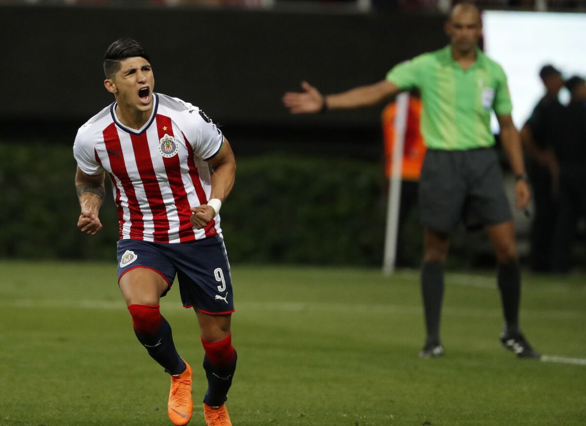 Chivas' Alan Pulido, left, celebrates scoring his penalty shot during a penalty shoot out with Toronto FC for the CONCACAF Champions League final soccer match in Guadalajara, Mexico, Wednesday, April, 25, 2018.