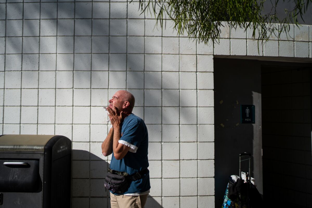 Terrance Whitten, 67, dries his face after washing   in the public restroom at the Pan Pacific Park on Friday.