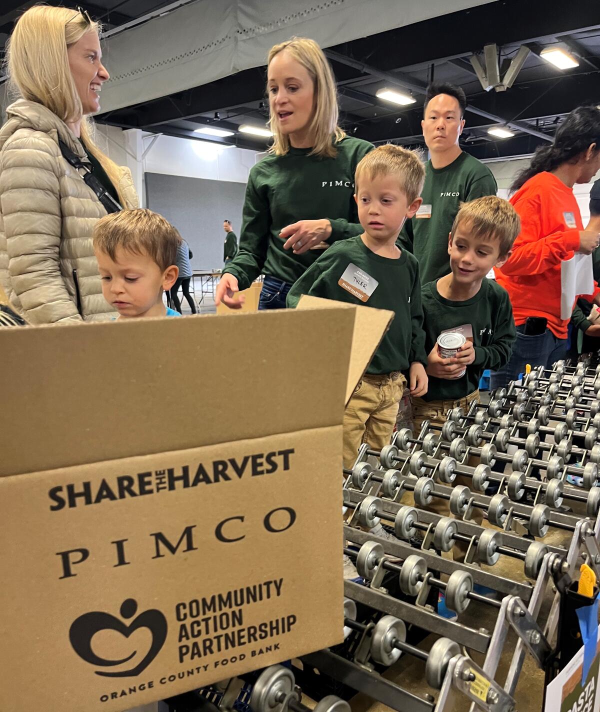 PIMCO employees and their family members wait Saturday to fill one of 15,000 boxes for O.C. families in need.