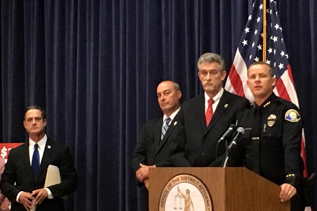 Newport Beach Police Chief Jon Lewis, right, discusses details of the arrest of murder suspect Peter Chadwick during a news conference Tuesday. Joining Lewis are, from right, David Singer of the U.S. Marshals Service, Newport Beach Deputy Chief Jay Short and Orange County District Attorney Todd Spitzer.