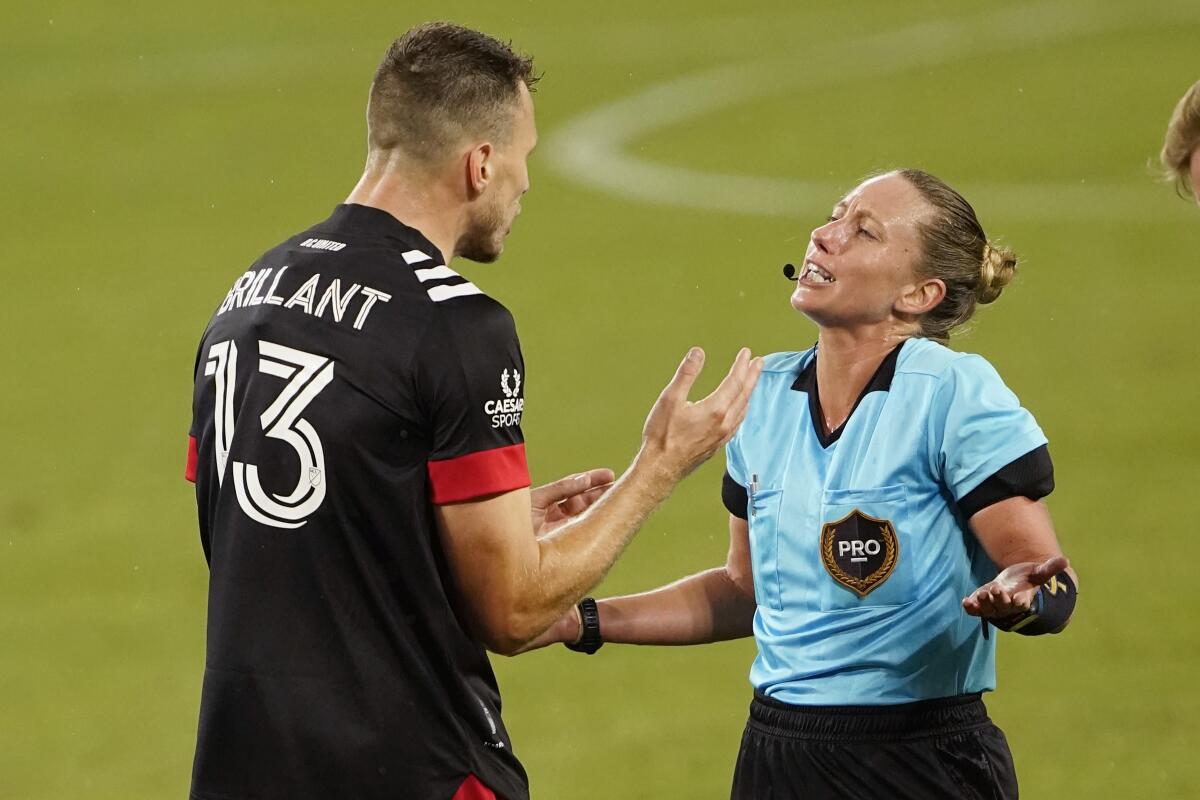 D.C. United defender Frédéric Brillant argues with referee Tori Penso.