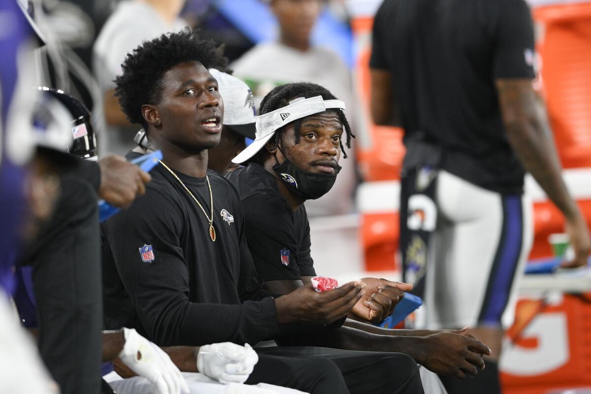 Baltimore Ravens wide receiver Sammy Watkins, left, and quarterback Lamar Jackson look on from the bench during the first half of an NFL preseason football game against the New Orleans Saints, Saturday, Aug. 14, 2021, in Baltimore. (AP Photo/Nick Wass)
