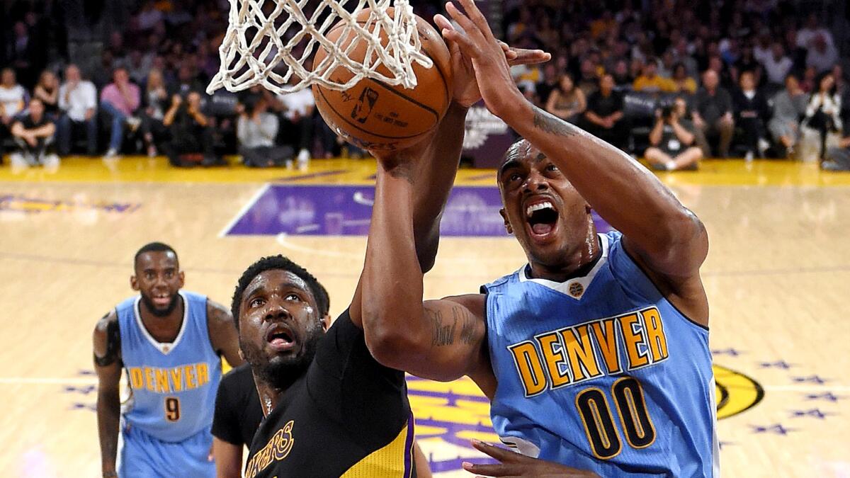 Lakers center Roy Hibbert tries to block a shot by Nuggets forward Darrell Arthur during the first half Friday.