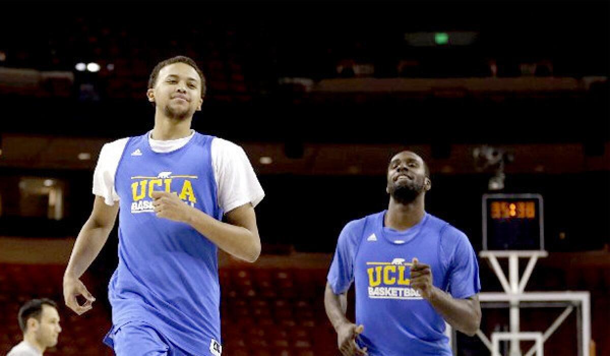 UCLA's Kyle Anderson runs with Shabazz Muhammad during practice for a second-round game of the NCAA college basketball tournament against the Minnesota Golden Gophers.