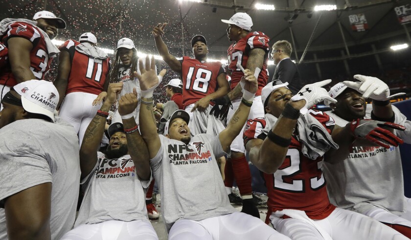 Atlanta Falcons players whoop it up Sunday after defeating the Green Bay Packers in the NFC championship game.