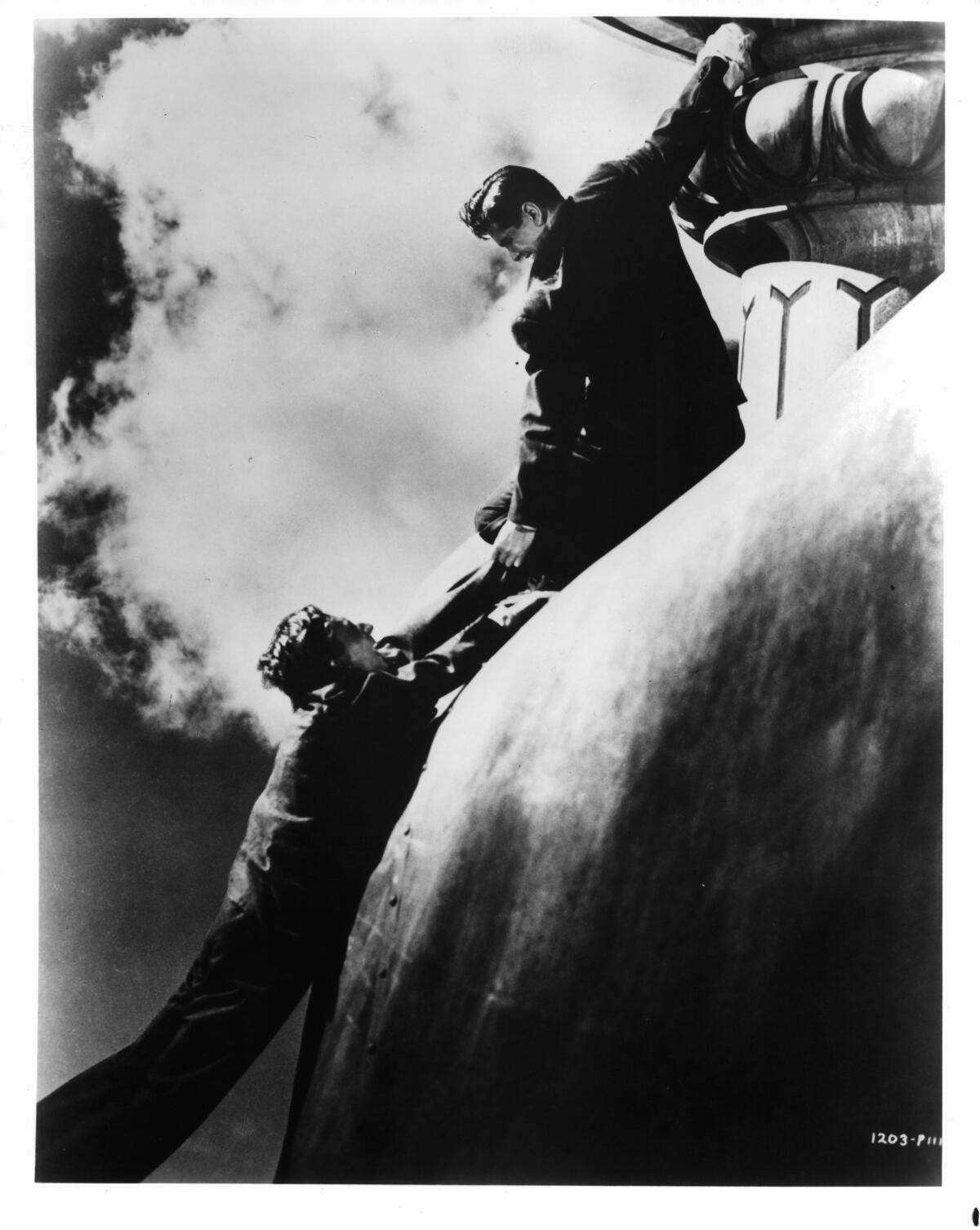 Norman Lloyd, left, and Robert Cummings fighting on top of the Statue of Liberty in a scene from the film 'Saboteur,' 1942.