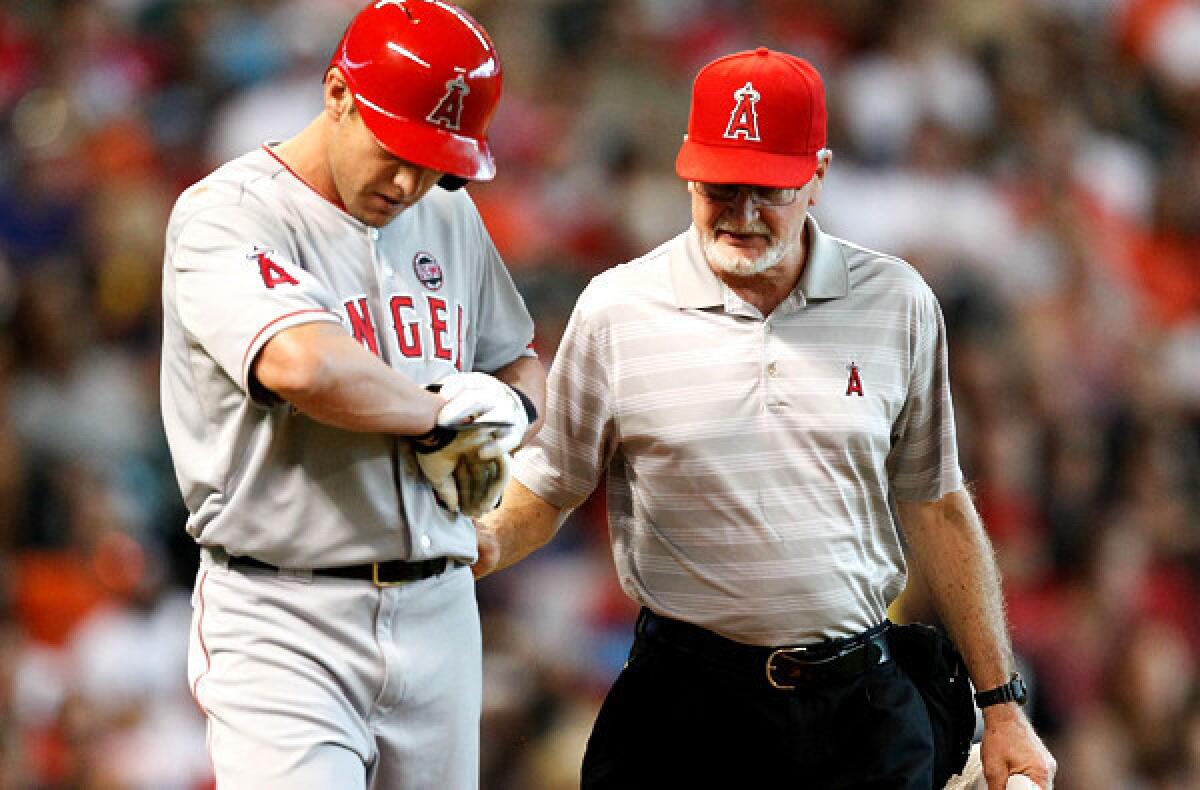 Angels center fielder Peter Bourjos checks his right wrist after getting hit by a pitch.