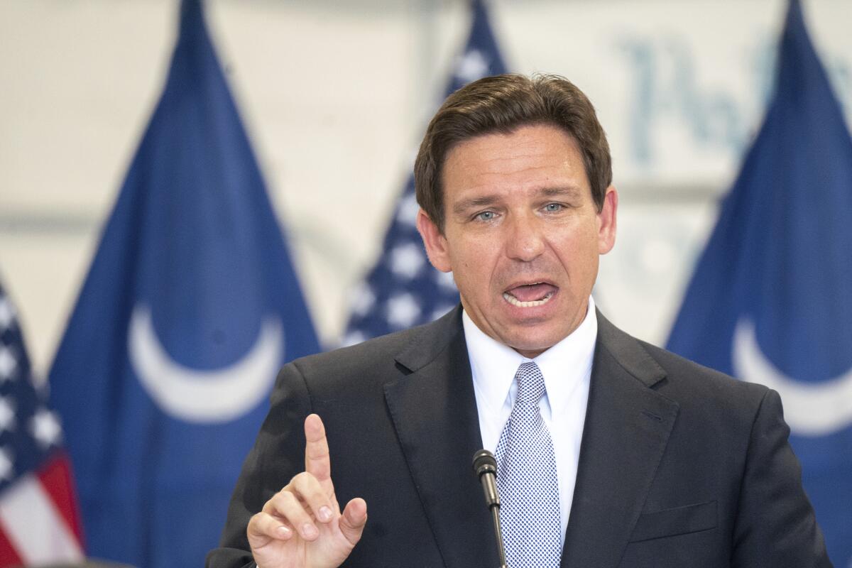 Ron DeSantis points while speaking at an event
