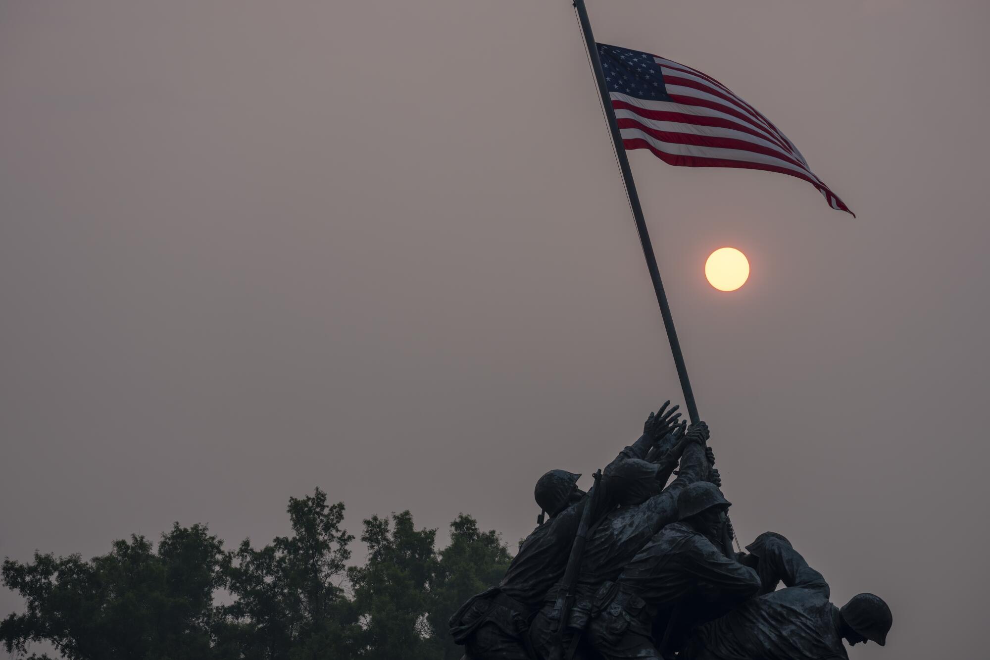 Haze blankets the United States Marine Corps War Memorial as the sun rises June 8 in Arlington, Va.