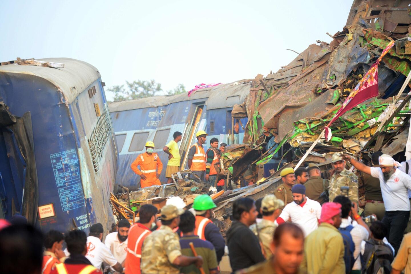 Indian rescue workers search for survivors in the wreckage of a train that derailed near Pukhrayan in Kanpur district on Nov. 20, 2016.