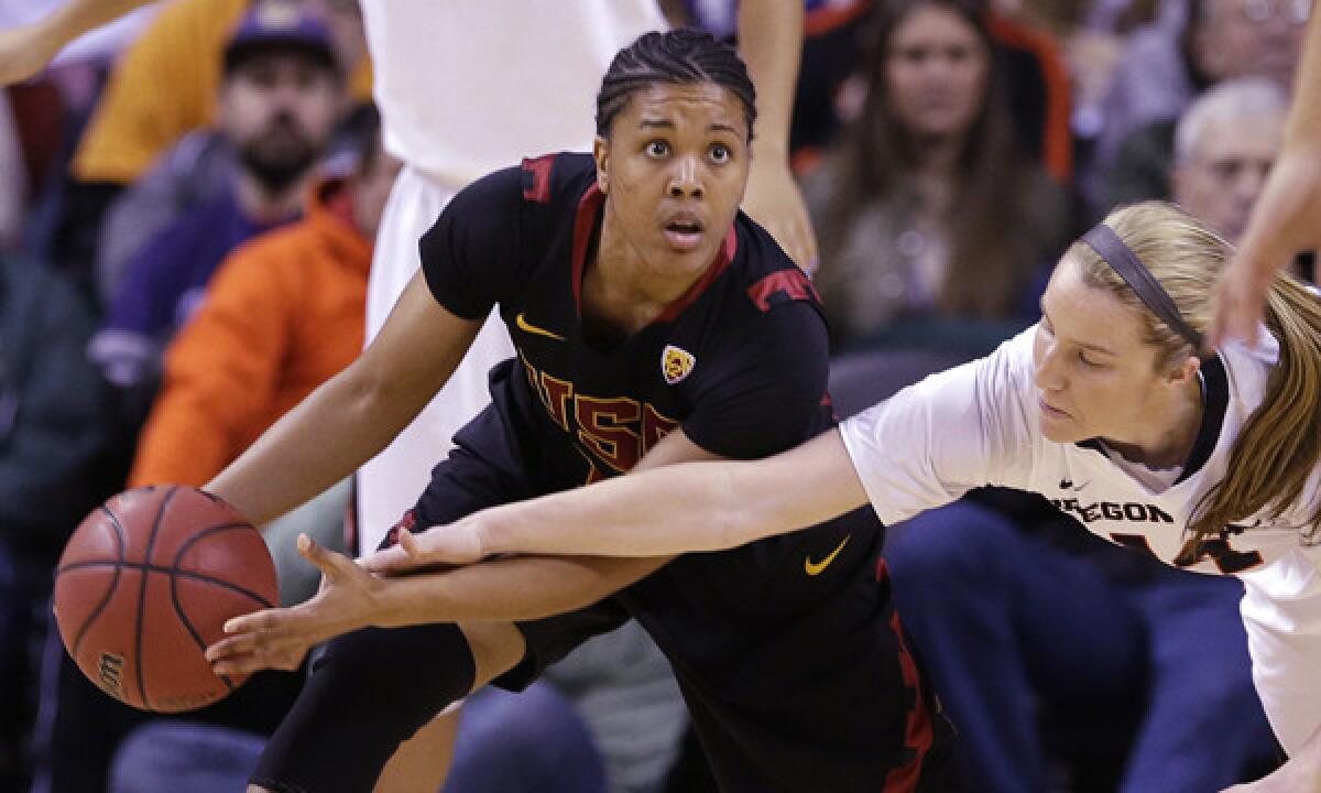 USC's Ariya Crook, left, fends off a steal attempt by Oregon State's Ali Gibson during the first half of the Trojans' 71-62 victory in the Pac-12 tournament championship game Sunday.