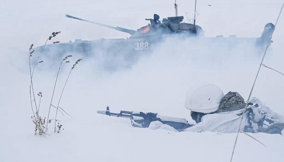 A Russian soldier and a tank in the snow