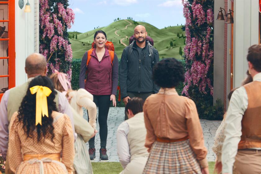 This image released by Apple TV+ shows Cecily Stron, background left, and Keegan-Michael Key in a scene from "Schmigadoon!,” premiering Friday. (Apple TV+ via AP)
