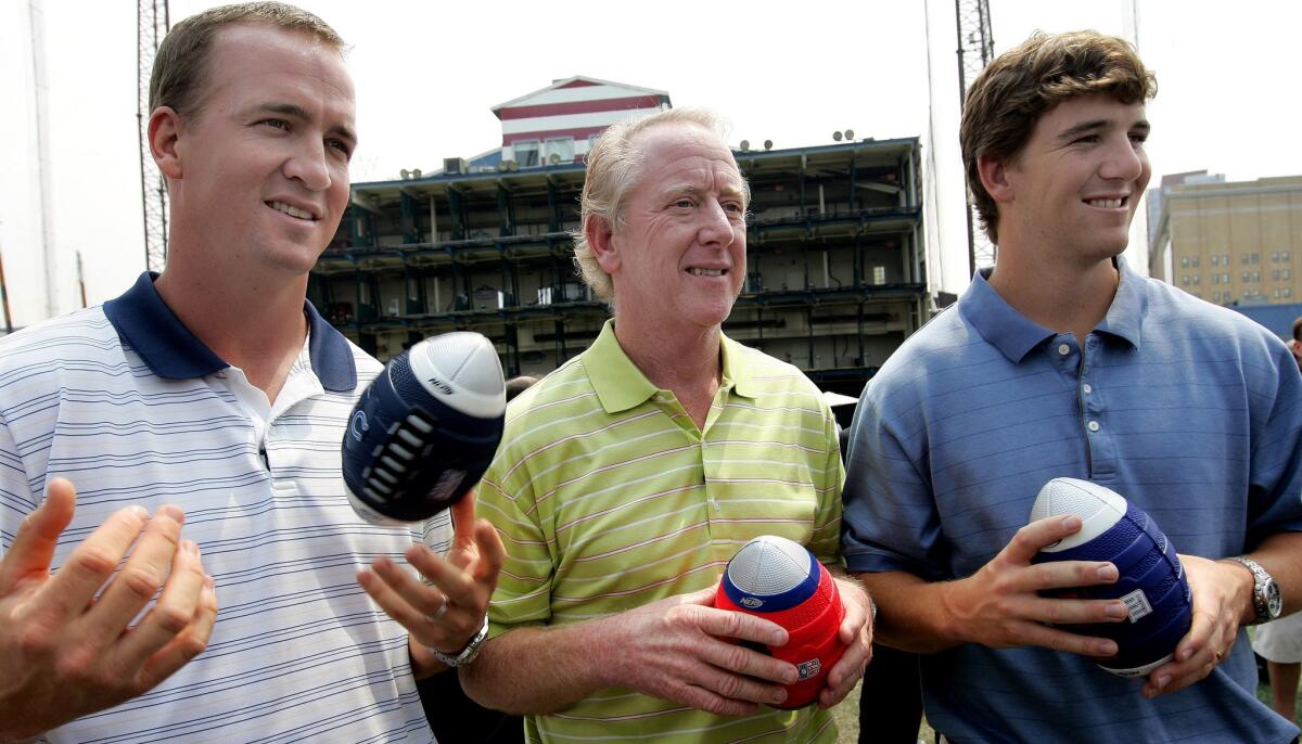Archie Manning, center, is flanked by his NFL football quarterback sons Peyton, left, and Eli during a promotional event in 2008.