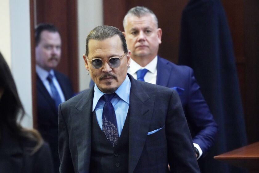Actor Johnny Depp arrives in the courtroom after lunch, at the Fairfax County Circuit Court in Fairfax, Va., Monday May 2, 2022. Depp sued his ex-wife Amber Heard for libel in Fairfax County Circuit Court after she wrote an op-ed piece in The Washington Post in 2018 referring to herself as a "public figure representing domestic abuse."(AP Photo/Steve Helber, Pool)