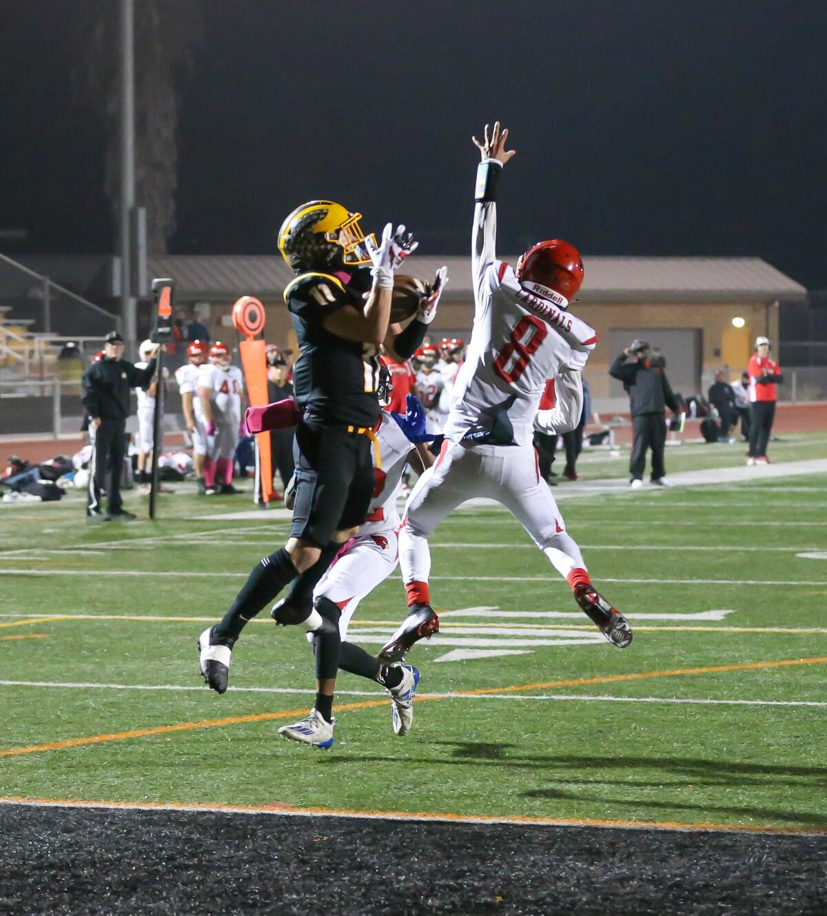 Mission Bay’s Jacob Sloan made catching TD passes a habit last year with 17, here grabbing one between two Hoover defenders.