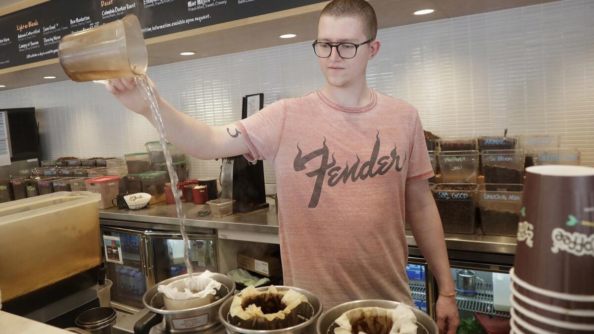 Adam Lange pours water while making coffee at a Philz Coffee shop in San Francisco. A judge ruled last March that coffee companies had to warn customers of a potentially carcinogenic chemical.