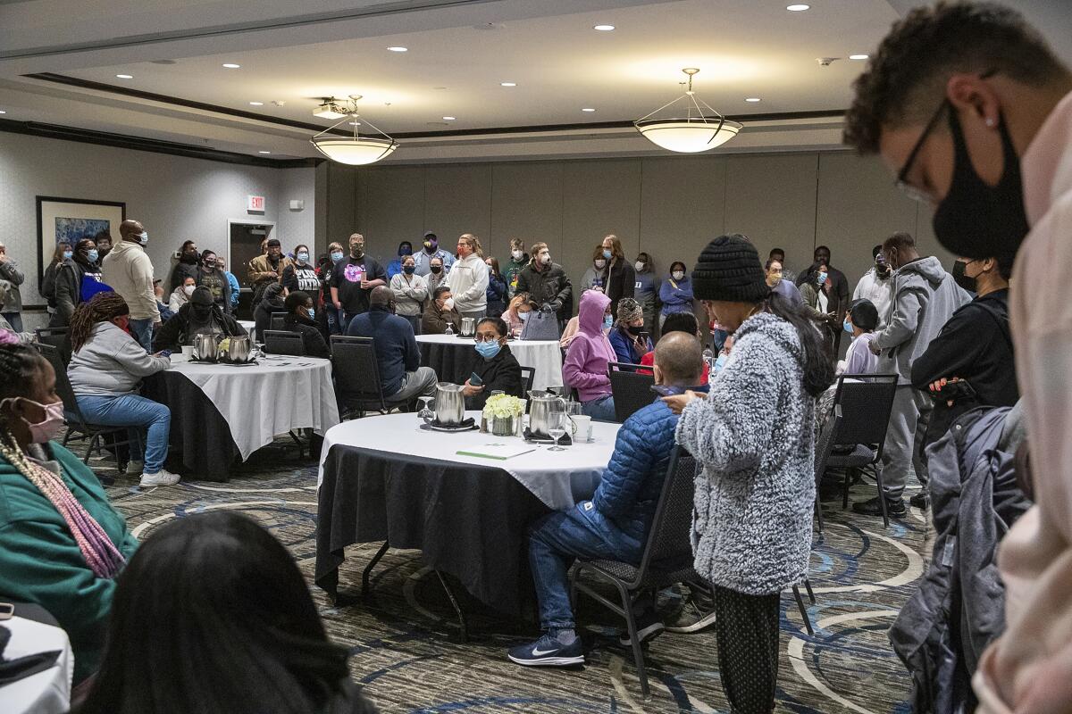 Relatives and friends of workers at the Indianapolis FedEx facility wait for information.