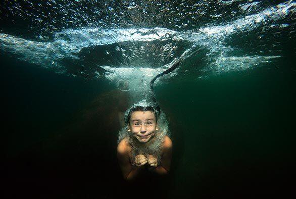 A girl takes a plunge in a lake west of St. Petersburg, Russia.