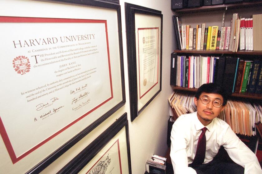 Jerry Kang, UCLA Law Prof. at 28 in his office at the University. On the wall are his diplomas from Harvard.Mandatory Credit: Lawrence K. Ho/The LA Times