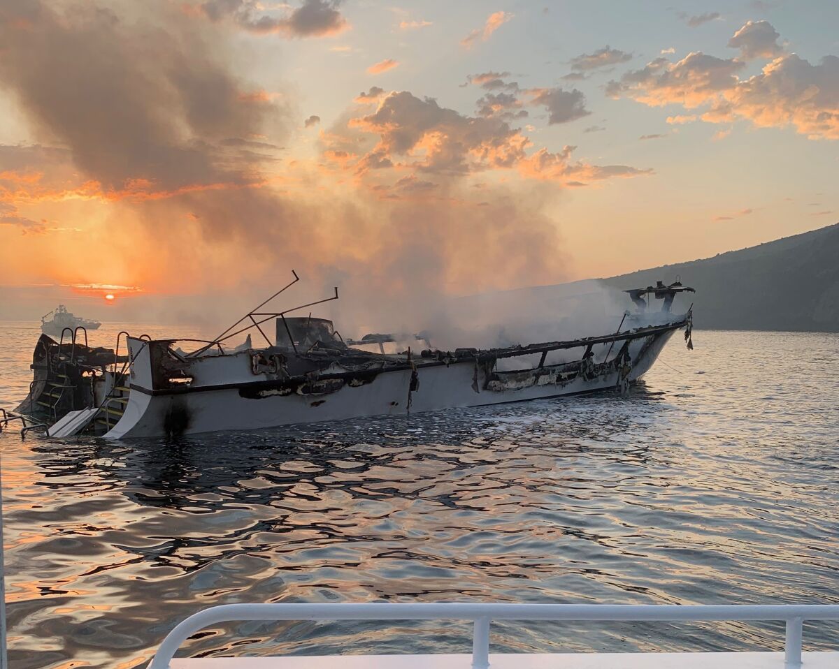 The dive boat Conception smolders at dawn Sept. 2, 2019, in the waters off Santa Cruz Island.
