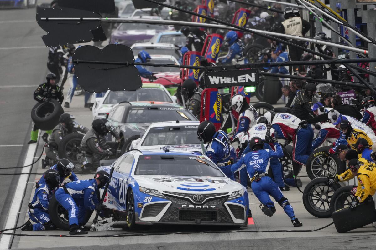 Christopher Bell makes a pit stop during a NASCAR Cup Series race at Auto Club Speedway in Fontana in 2023.